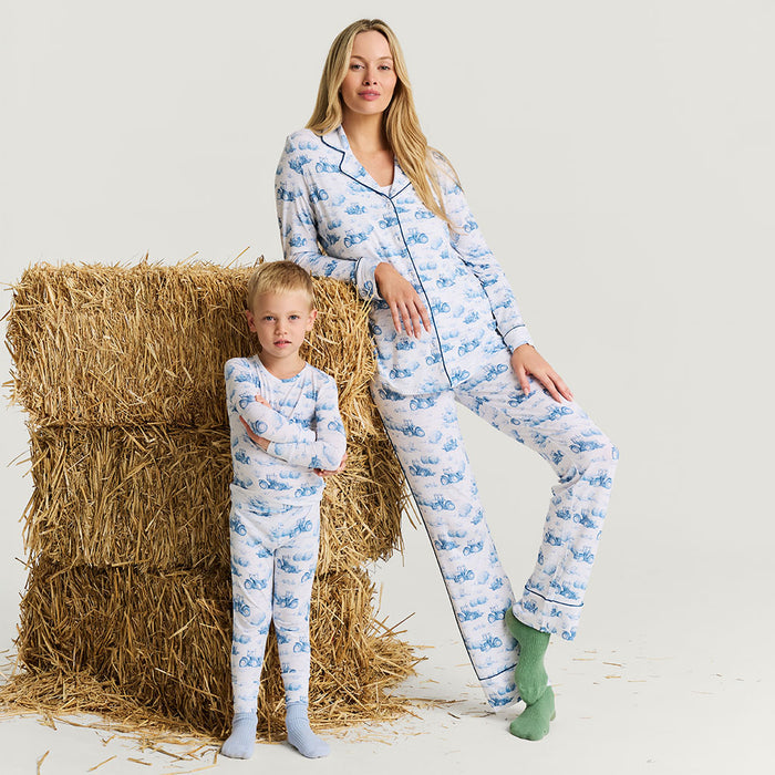 Woman and child wearing matching pajamas with a blue pattern on a white background