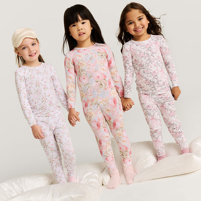 Three girls wearing floral printed pajama sets