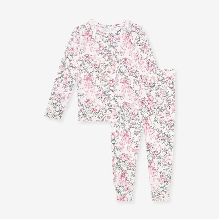 Floral and bow-patterned onesie on a white background
