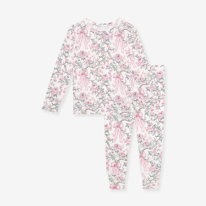 Floral and bow-patterned onesie on a white background