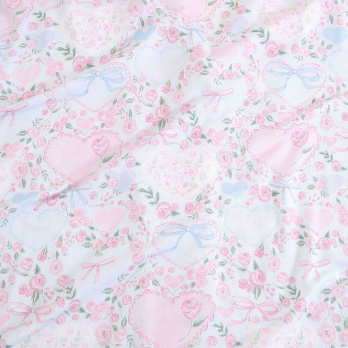 Floral pattern with pink flowers and blue ribbons on a light background