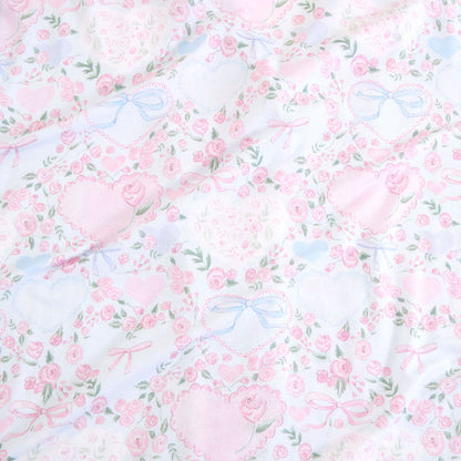 Floral pattern with pink flowers and blue ribbons on a white background