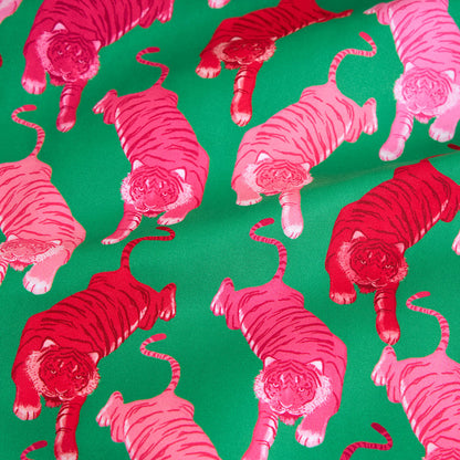 Pattern of pink and red tigers on a green background