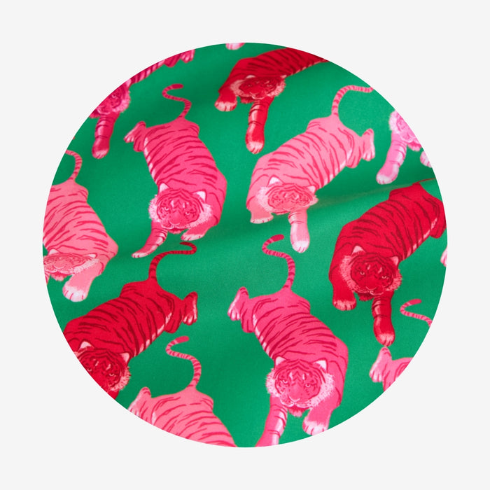 Pattern of pink tigers on a green background