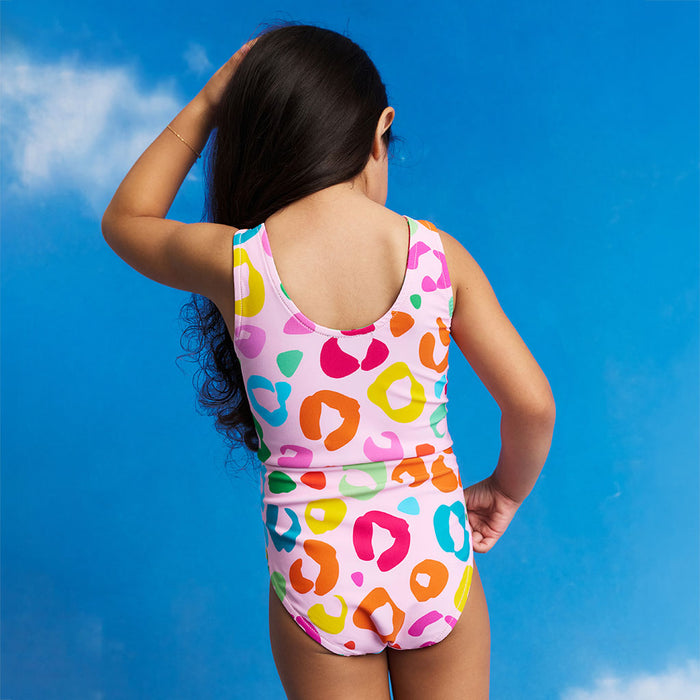 Child wearing a colorful swimsuit against a blue sky