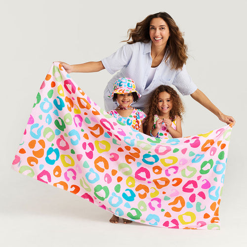 Woman and two children with a colorful leopard print towel