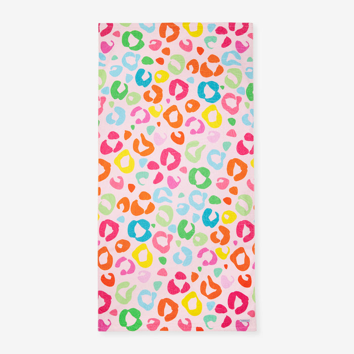 Colorful leopard print towel on a pink background