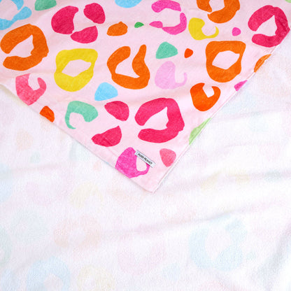 Colorful leopard print towel on a tie-dye background