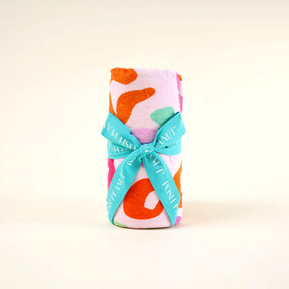 Colorful towel with a bow on a light background