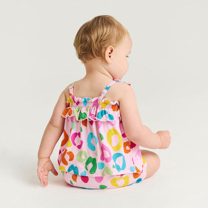 Baby wearing a colorful leopard print set on a white background