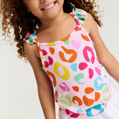 Child wearing a colorful leopard print top with a plain background