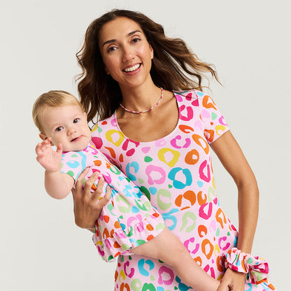 Woman and child wearing matching colorful pajamas with a pattern of multicolored shapes.