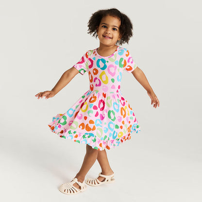 Child wearing a colorful dress with a white background