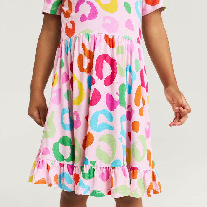 Colorful dress with multicolored leopard print on a plain background