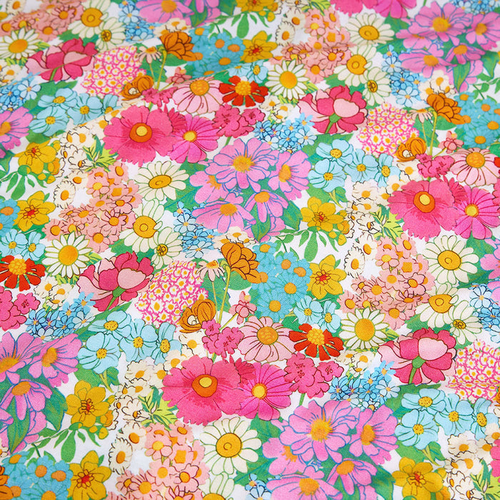 Colorful floral pattern with various flowers on a multicolored background