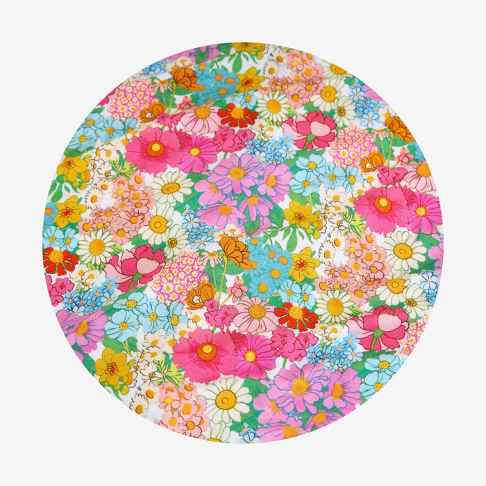 Round floral swatch with colorful flowers on a white background