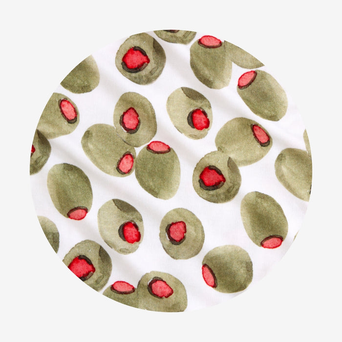 Circular fabric swatch with green olives and red centers on a white background