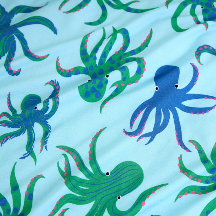 Pattern of blue and green octopuses on a light blue background
