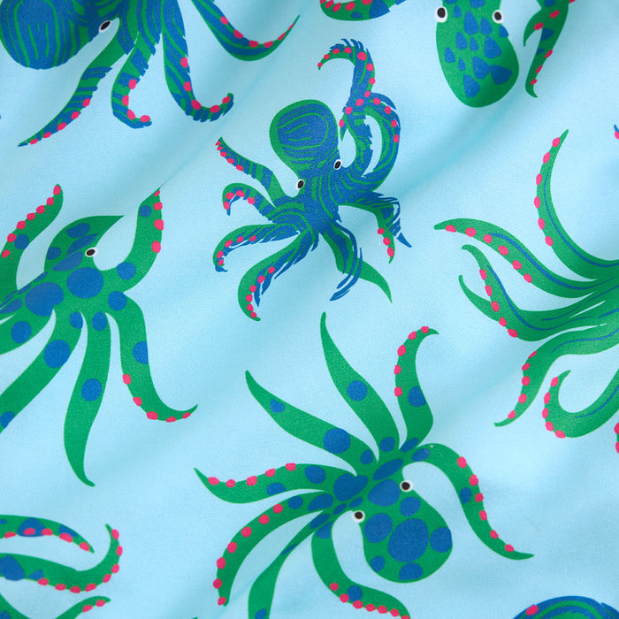 Pattern of green and blue octopuses on a light blue background
