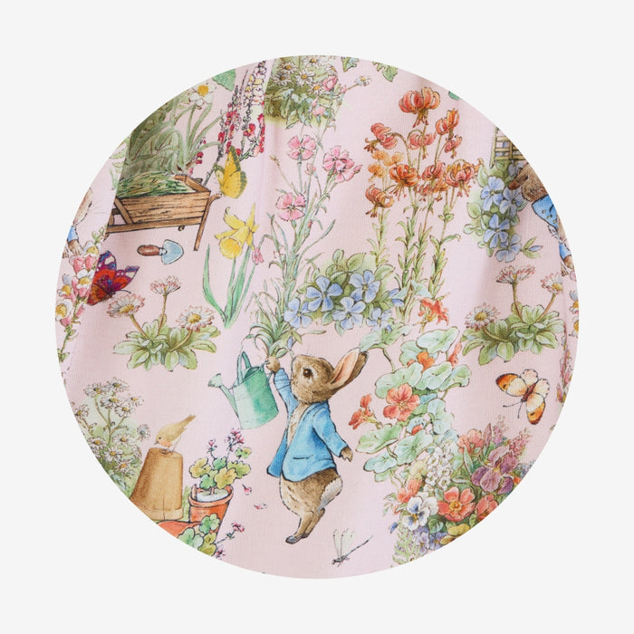 Round plate with a garden-themed design featuring a rabbit character and flowers.