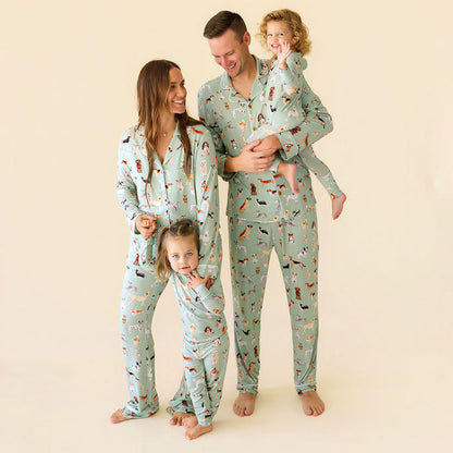 Family of four wearing matching pajamas with a pattern on a beige background