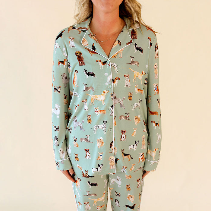 Light blue pajama top with dog pattern worn by a person on a beige background