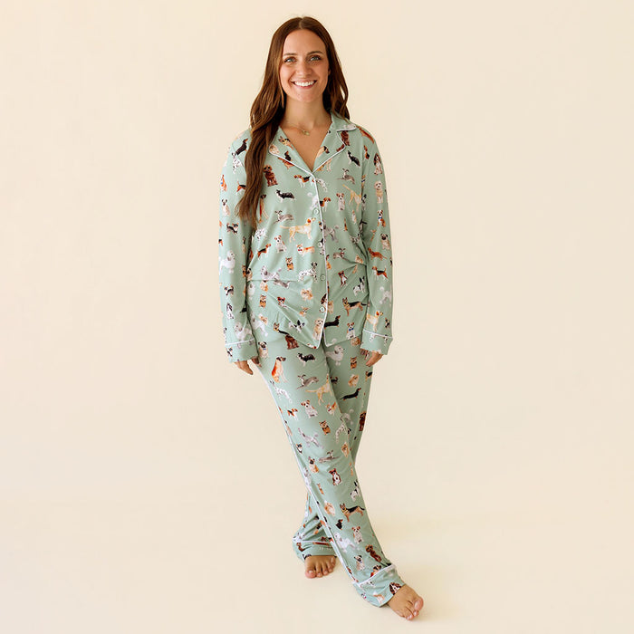 Woman wearing a light blue pajama set with dog pattern on a beige background