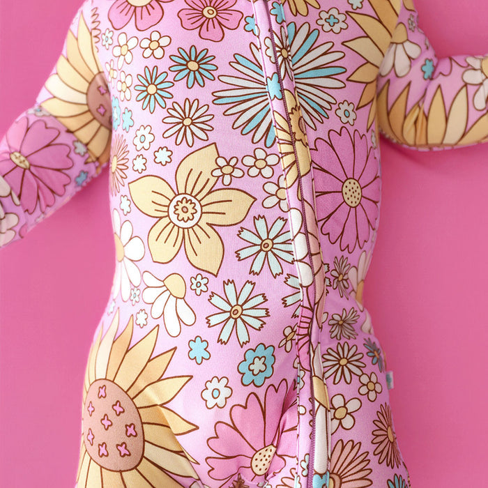 Floral-patterned onesie on a pink background