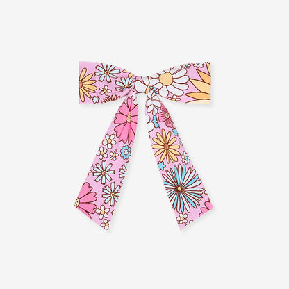 Floral patterned hair bow on a white background