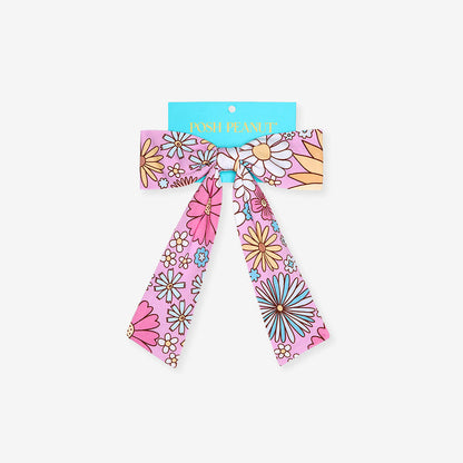 Floral patterned hair bow with a blue band on a white background