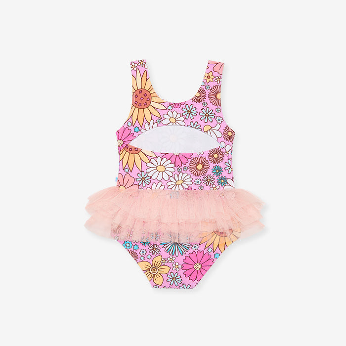 Colorful children's swimsuit with floral design and pink tutu on a white background