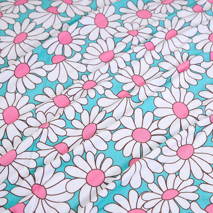 Pattern of white daisies with pink centers on a turquoise background