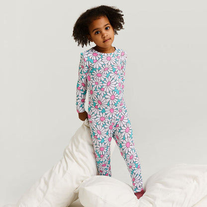 Child wearing a floral pajama set on a white background