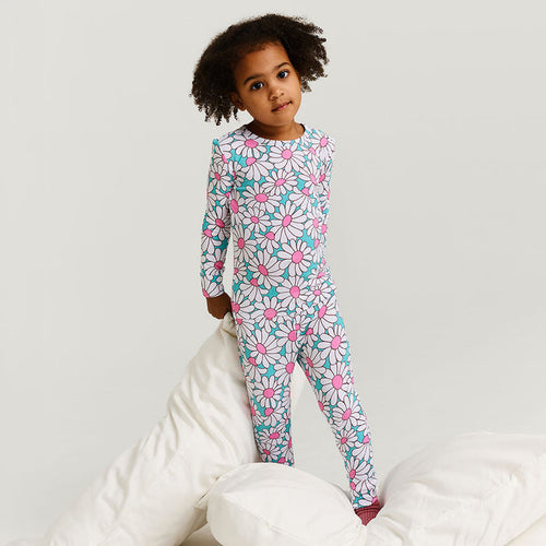 Child wearing a floral pajama set on a white background