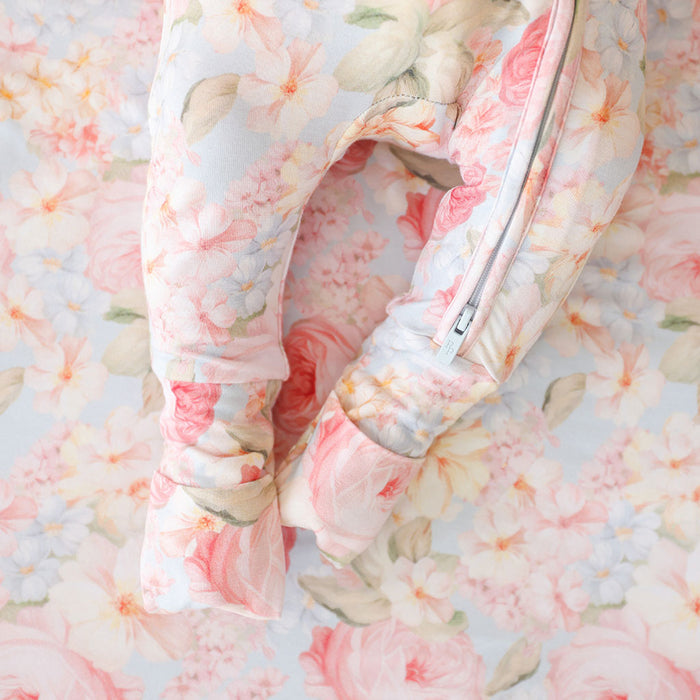 Floral-patterned quilt with a zipper on a floral background