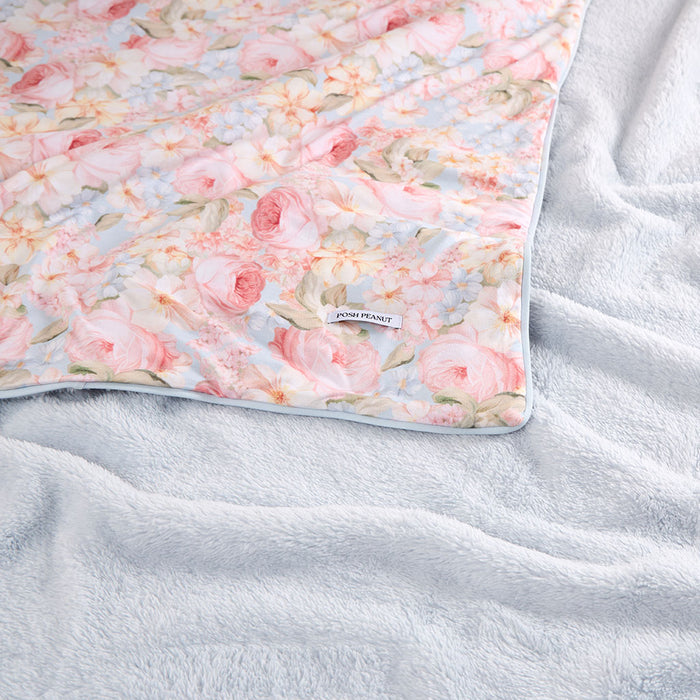 Floral-patterned blanket on a textured surface