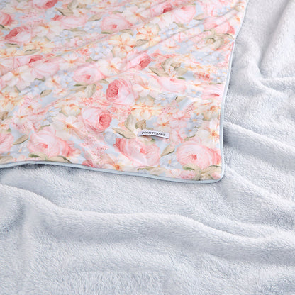 Floral-patterned blanket on a textured surface