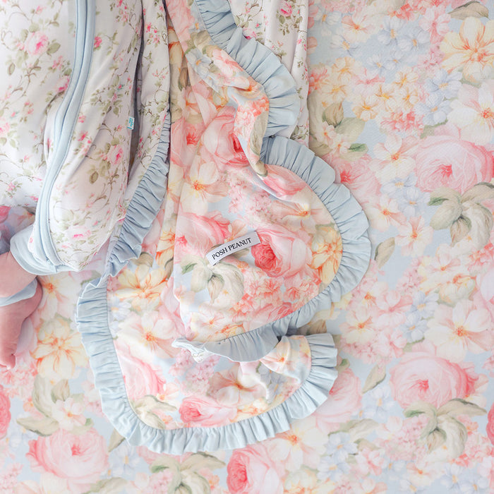 Floral-patterned baby outfit with ruffles on a floral background