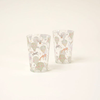 Two clear glasses with colorful animal illustrations on a white background