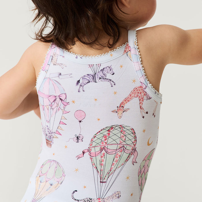 Child wearing a sleeveless bodysuit with animal and hot air balloon print on a plain background