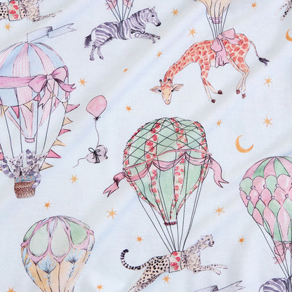 Children's fabric with hot air balloons and animals on a light blue background