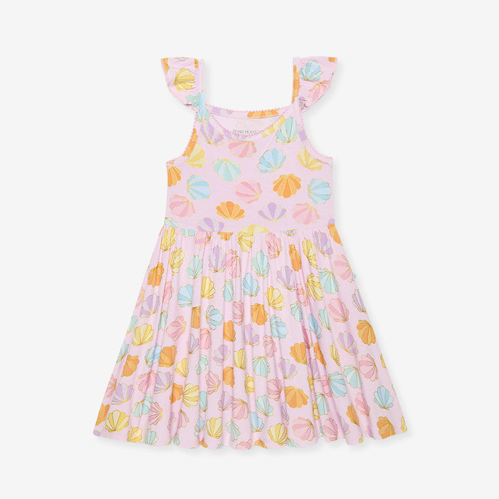 Pink dress with colorful shell pattern on a white background