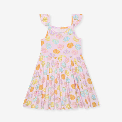 Pink dress with colorful shell pattern on a white background