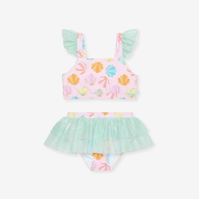 Pastel-colored children's swimsuit with shell pattern on a white background