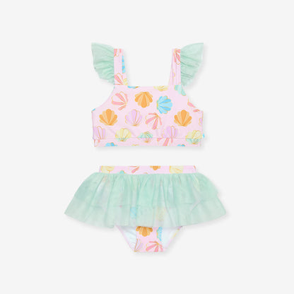 Pastel-colored children's swimsuit with shell pattern on a white background