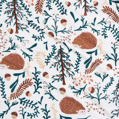 Pattern of hedgehogs, trees, and foliage on a white background
