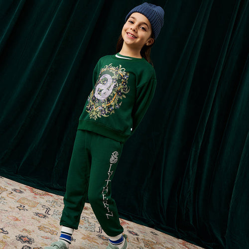 Child wearing green Harry Potter Slytherin sweatshirt and jogger set.