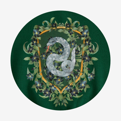 Circle swatch of green Harry Potter Slytherin logo on green fabric.