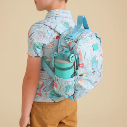 Child wearing a blue backpack with a water bottle holder on a beige background