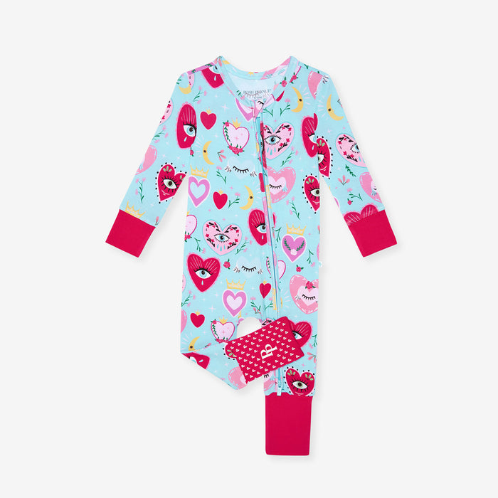 Children's one piece with heart pattern on a light blue background
